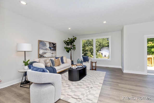 living room featuring a wealth of natural light, recessed lighting, and wood finished floors