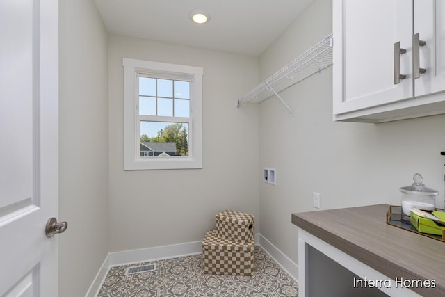 laundry room with hookup for a washing machine, cabinet space, baseboards, and visible vents