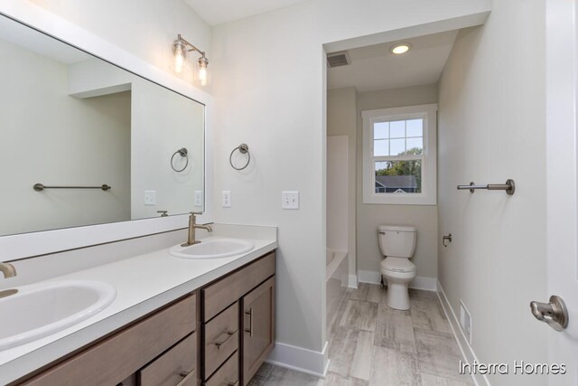 full bathroom with vanity, shower / bath combination, and toilet