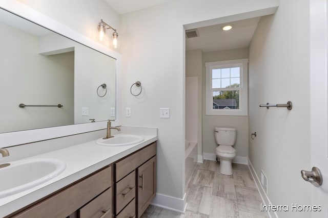 full bathroom featuring double vanity, visible vents, and a sink