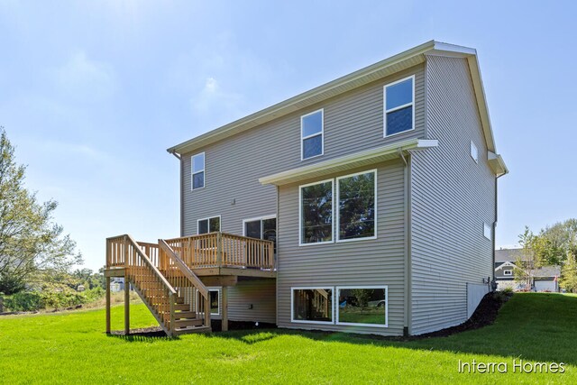 rear view of property featuring a wooden deck and a yard