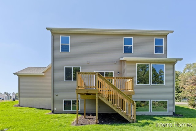 back of house featuring stairway, a lawn, and a deck