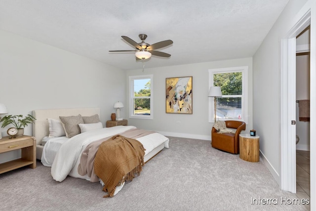 bedroom with baseboards, carpet floors, and ceiling fan