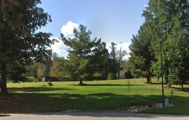 view of property's community with a lawn