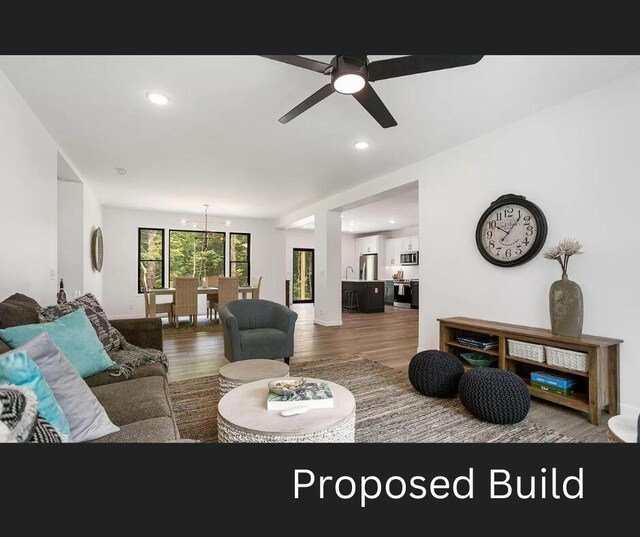 living room with hardwood / wood-style flooring and ceiling fan