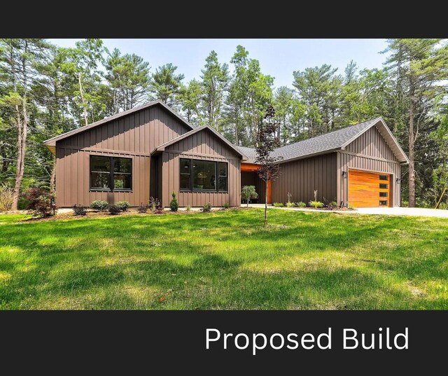 view of front of home featuring a garage and a front lawn