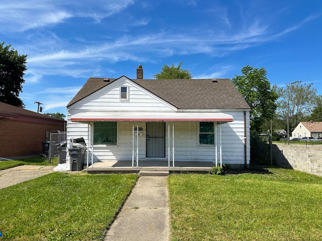 bungalow-style home featuring a porch and a front lawn