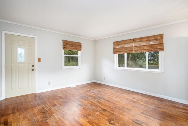 interior space with hardwood / wood-style flooring, crown molding, and plenty of natural light