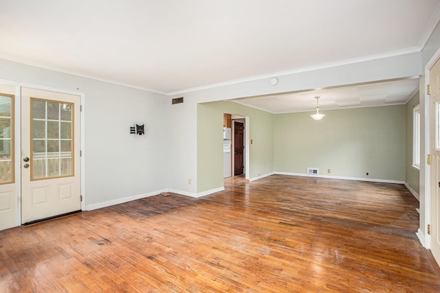 empty room with ornamental molding and wood-type flooring