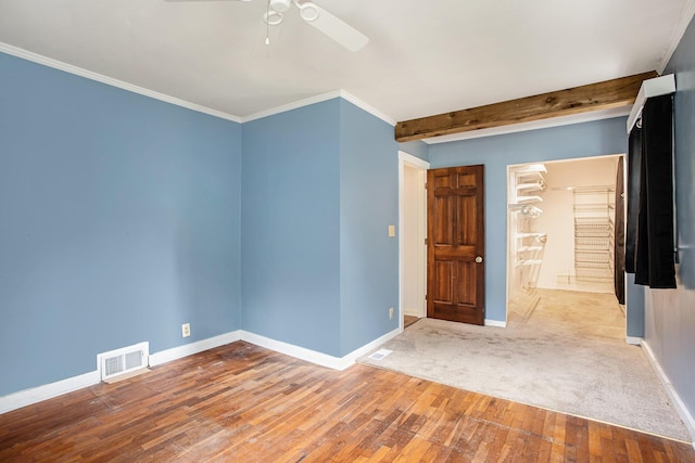 spare room featuring ceiling fan, ornamental molding, and wood-type flooring