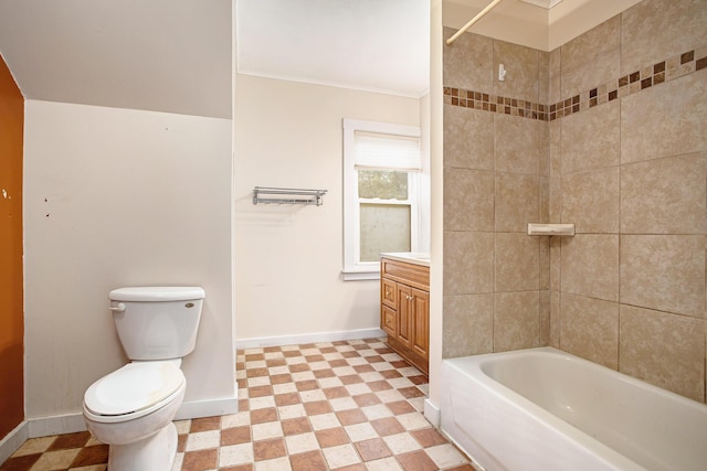 full bathroom featuring vanity, tiled shower / bath, and toilet