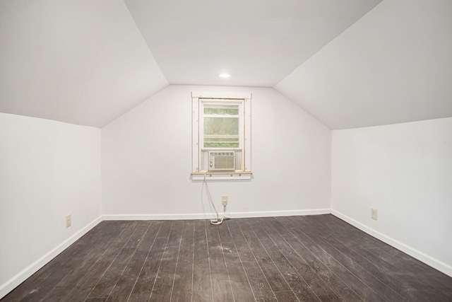 bonus room featuring dark wood-type flooring, lofted ceiling, and cooling unit