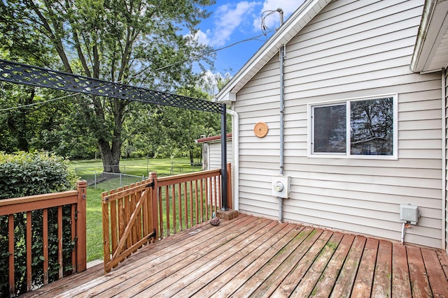 wooden deck featuring a yard