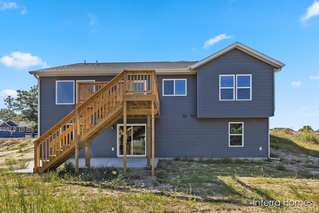 rear view of property featuring a deck