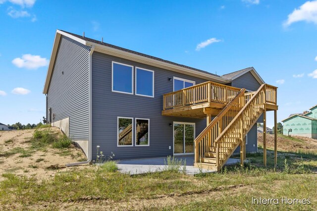 rear view of house with a wooden deck