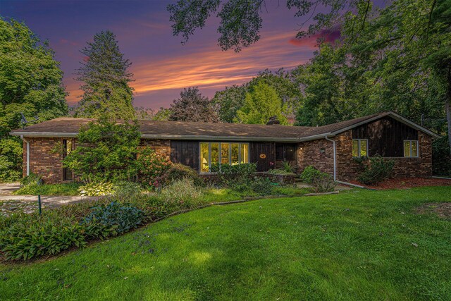 ranch-style home with a lawn