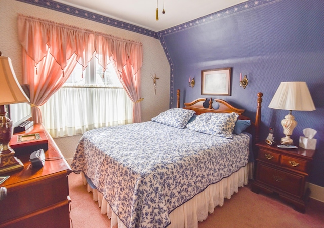 bedroom featuring carpet and vaulted ceiling