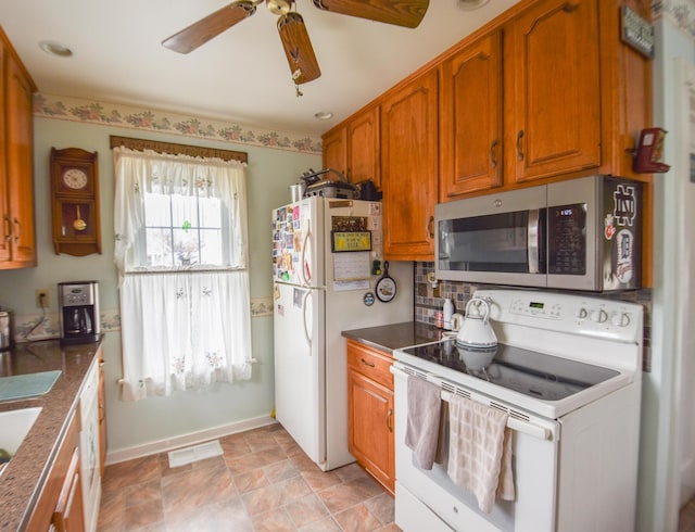 kitchen featuring ceiling fan and white appliances