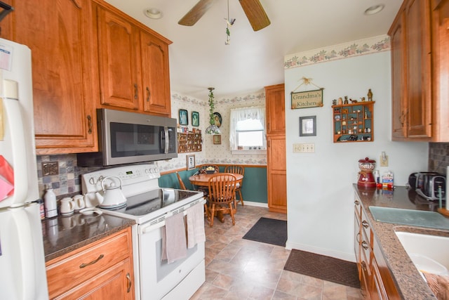 kitchen featuring ceiling fan, decorative backsplash, white appliances, and sink