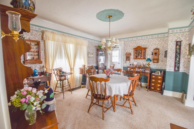 dining area featuring carpet flooring and an inviting chandelier