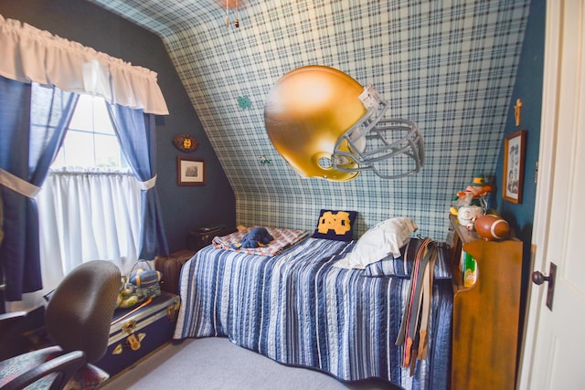 bedroom with carpet flooring and lofted ceiling