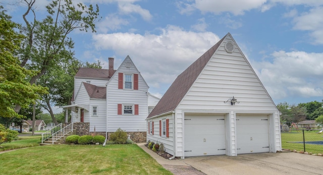 view of front of home with a garage and a front lawn