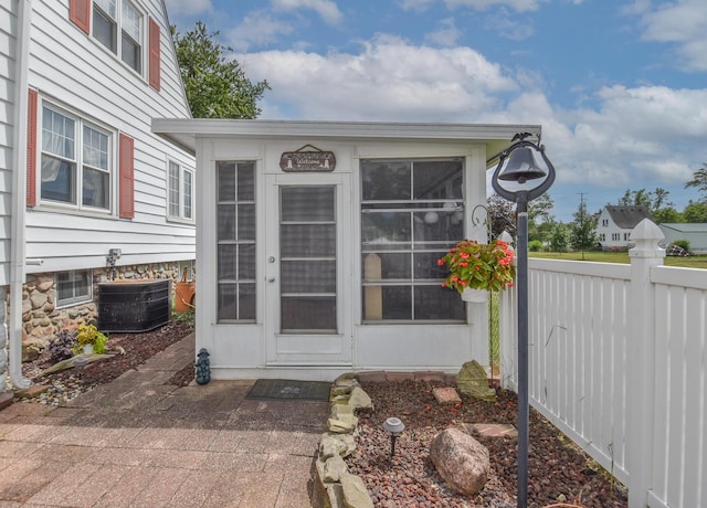 entrance to property featuring cooling unit