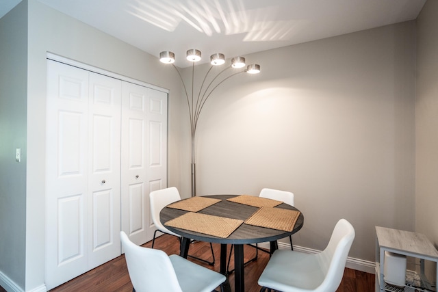 dining area featuring dark wood-type flooring