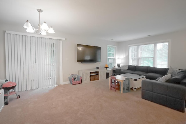 carpeted living room with a notable chandelier