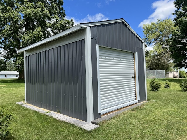 view of outbuilding with a garage and a yard