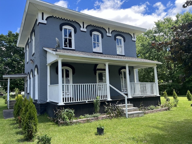 italianate home featuring a porch and a front yard