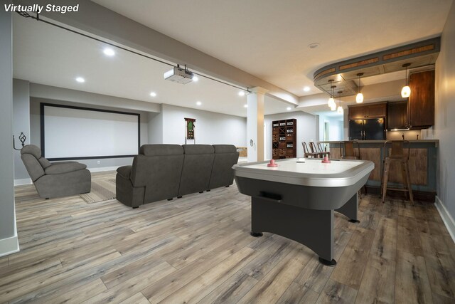 game room featuring bar and light wood-type flooring