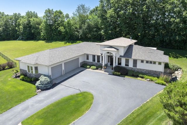 view of front facade featuring a garage and a front lawn