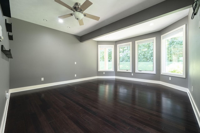 empty room with ceiling fan and dark hardwood / wood-style floors