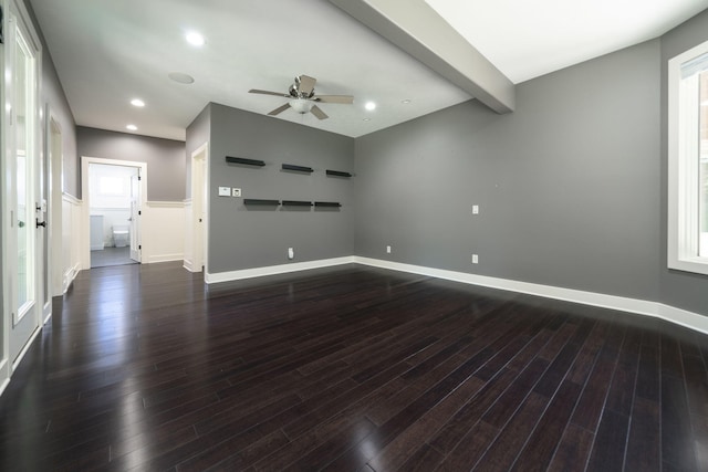 unfurnished room featuring beamed ceiling, ceiling fan, and dark hardwood / wood-style flooring