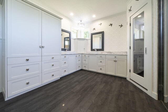 bathroom featuring decorative backsplash, hardwood / wood-style floors, vanity, and ornamental molding