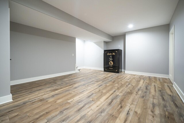 basement with light hardwood / wood-style floors