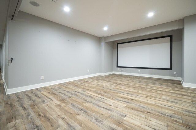 cinema with light wood-type flooring