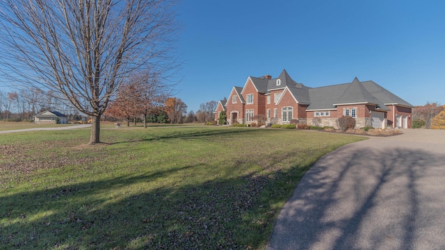 view of front of home featuring a garage and a front lawn