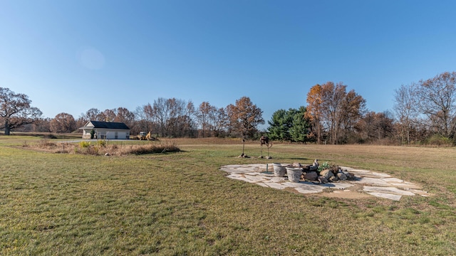 view of yard with an outdoor fire pit