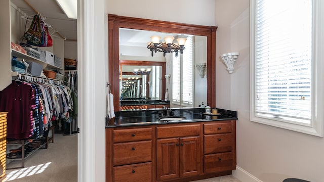 bathroom with an inviting chandelier and vanity