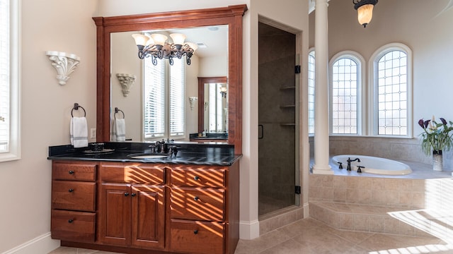 bathroom featuring ornate columns, plus walk in shower, tile patterned floors, and vanity