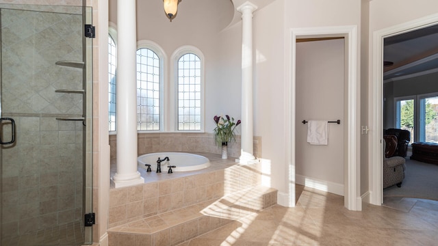 bathroom with decorative columns and plus walk in shower