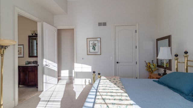 carpeted bedroom featuring connected bathroom