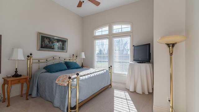 bedroom featuring light colored carpet and ceiling fan