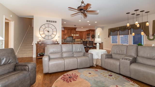 living room with dark wood-type flooring and ceiling fan