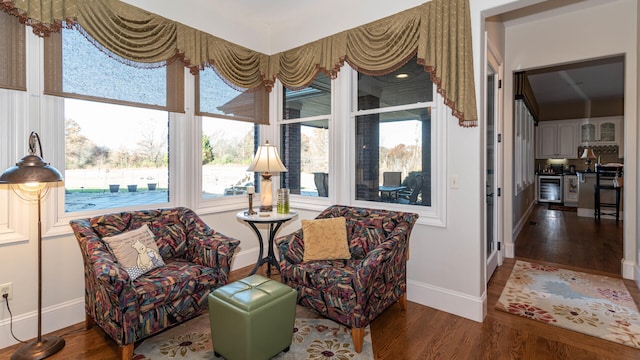 living area with a healthy amount of sunlight and hardwood / wood-style floors