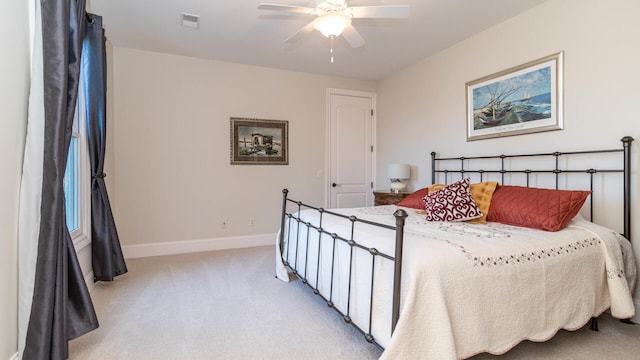 bedroom featuring light colored carpet and ceiling fan