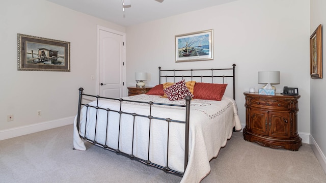 bedroom with ceiling fan and light carpet