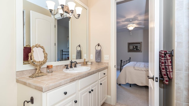 bathroom with vanity and ceiling fan with notable chandelier